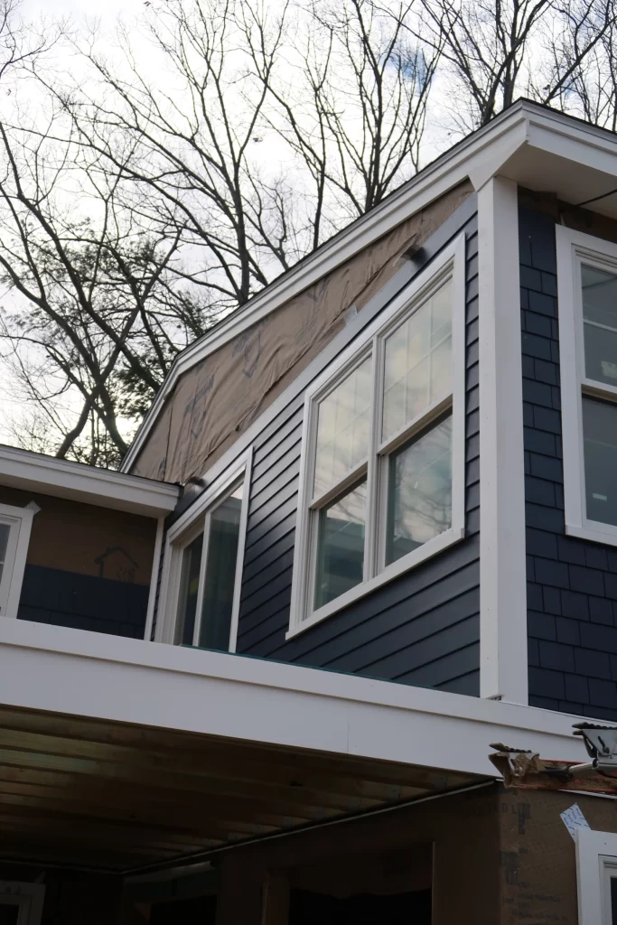 Blue vinyl siding installation on a new construction home.